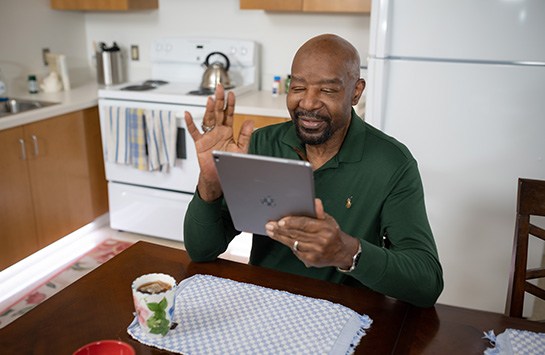 Man sitting at home using a laptop for a telehealth video visit