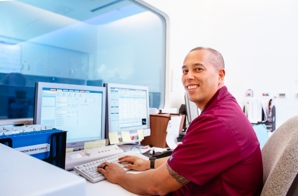 Radiation therapist reviews treatment planning data on a computer workstation
