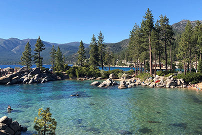 Lakeside with rocks and trees in the background