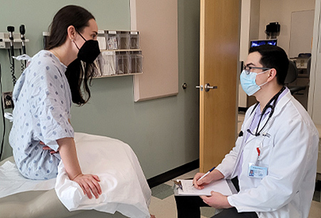 A doctor working with a person acting as a standardized patient. 