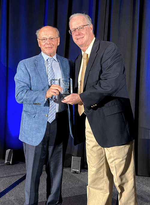 Frederick J. Meyers accepted awards from Allan R. Brasier.