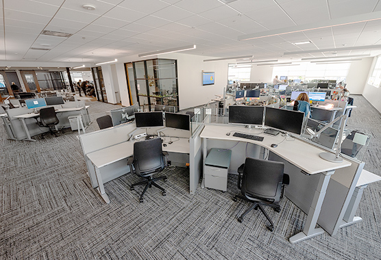 An office space with desks and workers in the background.
