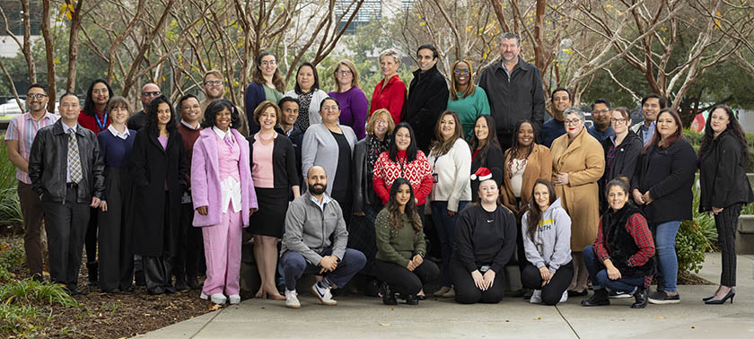 Department of Radiology administration staff posing outside with trees in the background